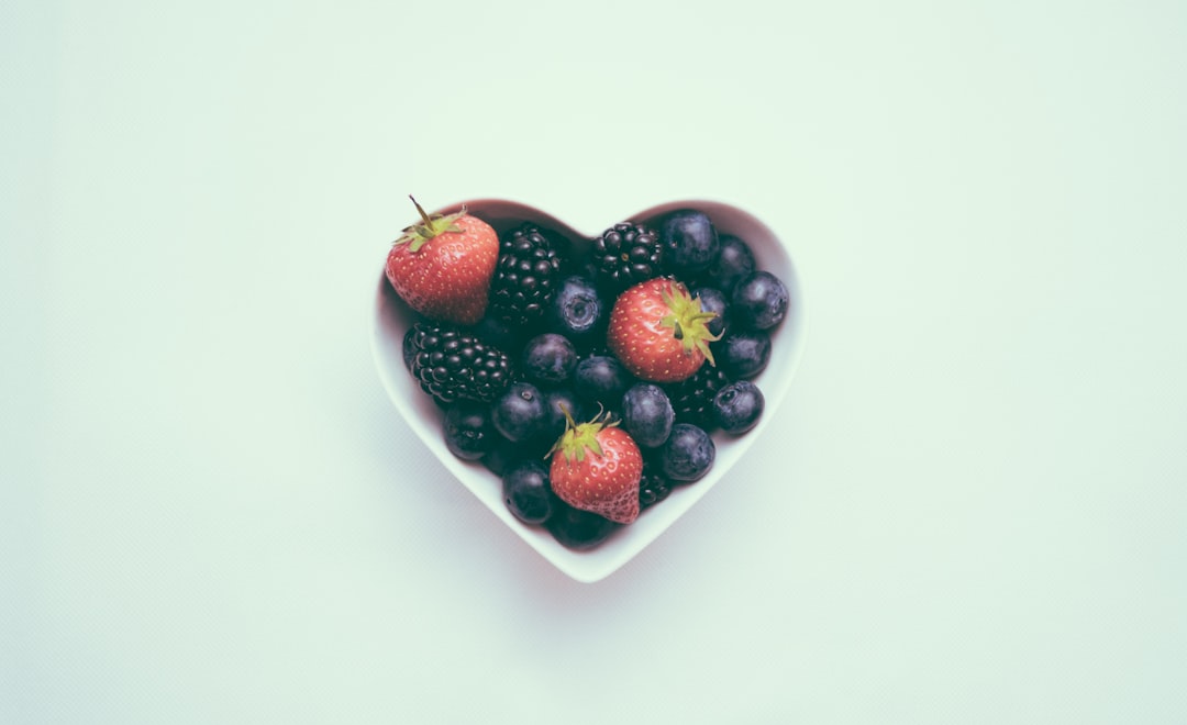 heart-shaped bowl with strawberries