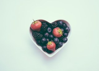 heart-shaped bowl with strawberries