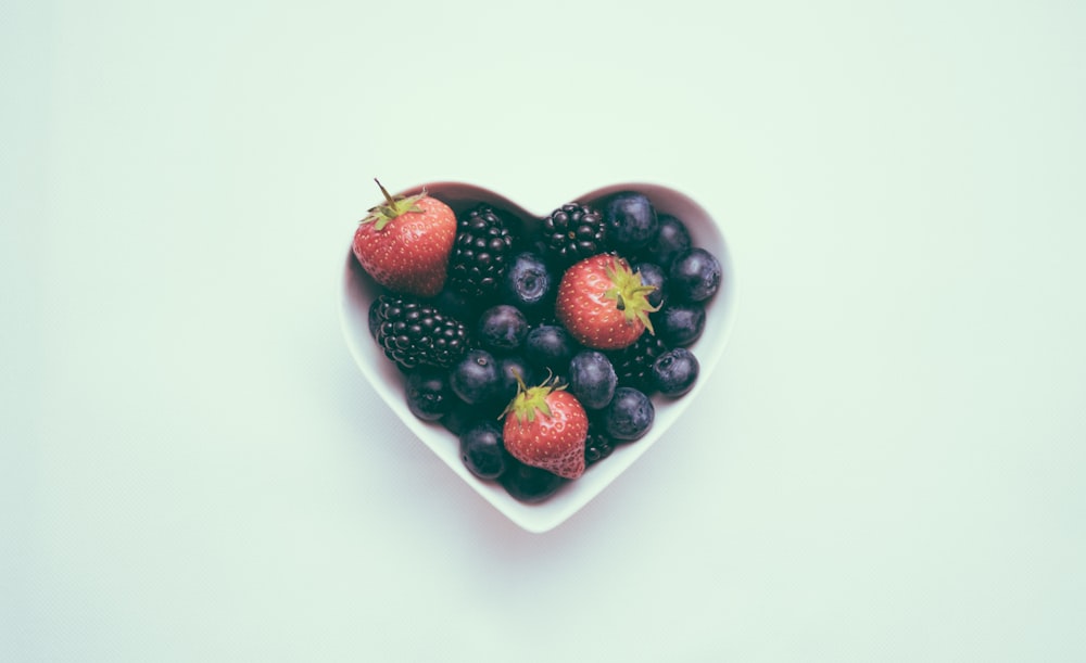 heart-shaped bowl with strawberries