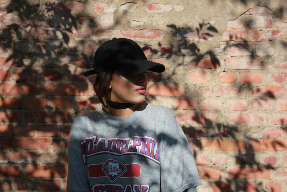 woman leaning on concrete brick walling