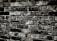 Rough-textured brick wall with dark mortar lines, showcasing an aged, worn appearance.