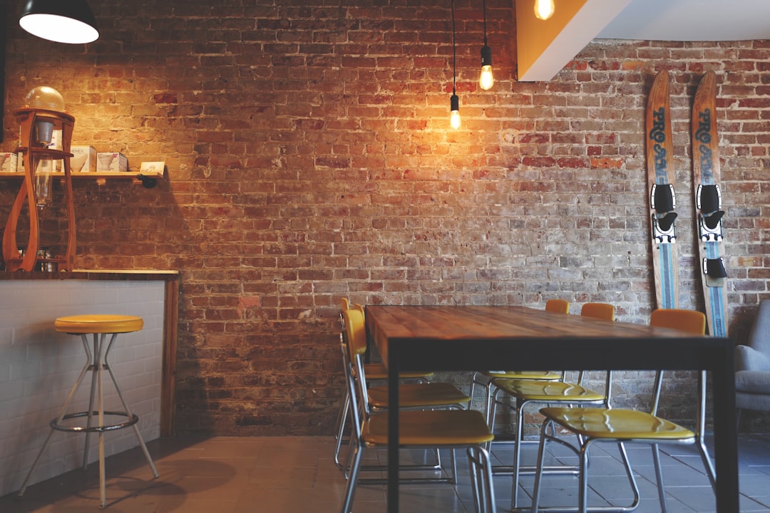brown wooden dining table near white and brown mini bar, Water skis in a cozy coffee shop