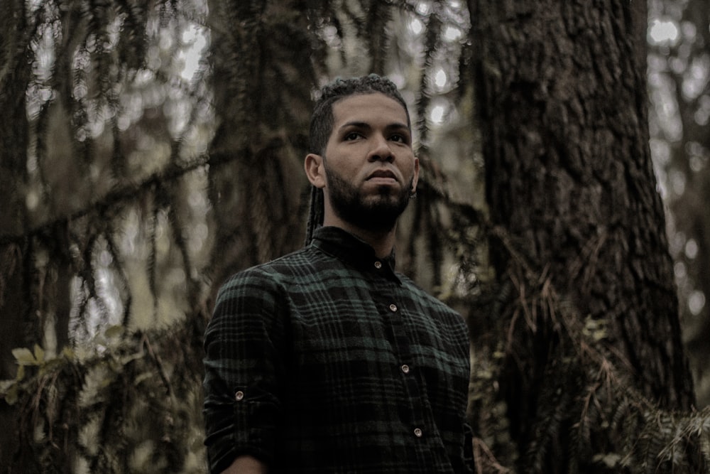 a man standing in the middle of a forest