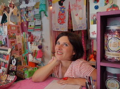 woman leaning on pink desk