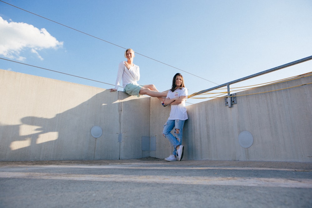 two women's on brown wall