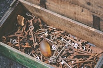A rustic wooden chest filled with assorted vintage relics and artifacts.
