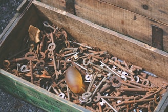A vintage wooden chest filled with assorted antique items and trinkets.