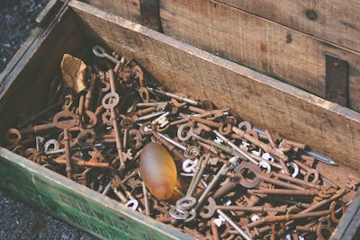 An old wooden chest filled with assorted antique trinkets and collectibles.