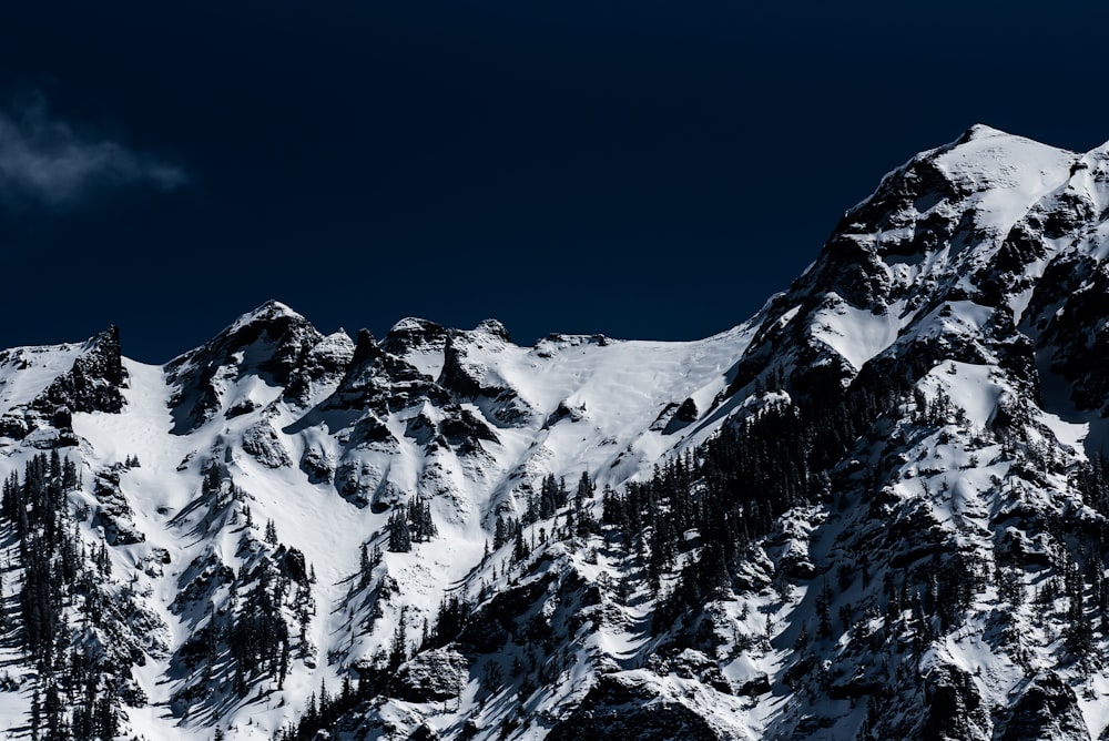 mountains with snow under gray sky