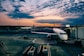 white airplane near trailers during sunset