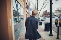 person walking beside street at daytime