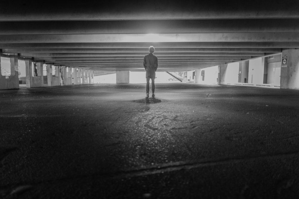 men under a building grey-scale photography