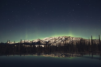 A serene lakeside view under the northern lights, evoking the spirit of old Finland.