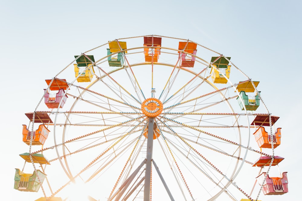 worm's eye view of red, orange, and yellow Ferris wheel