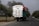 A truck loaded with cargo driving on a rural road.