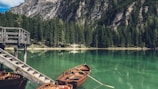 brown canoe docking on gray wooden staircaes