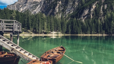 brown canoe docking on gray wooden staircaes