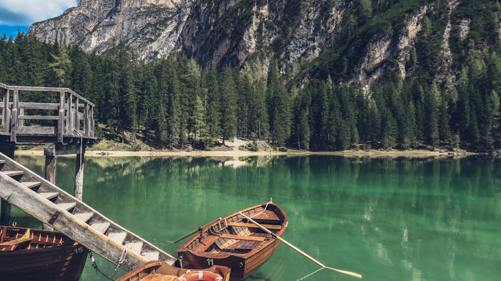 brown canoe docking on gray wooden staircaes