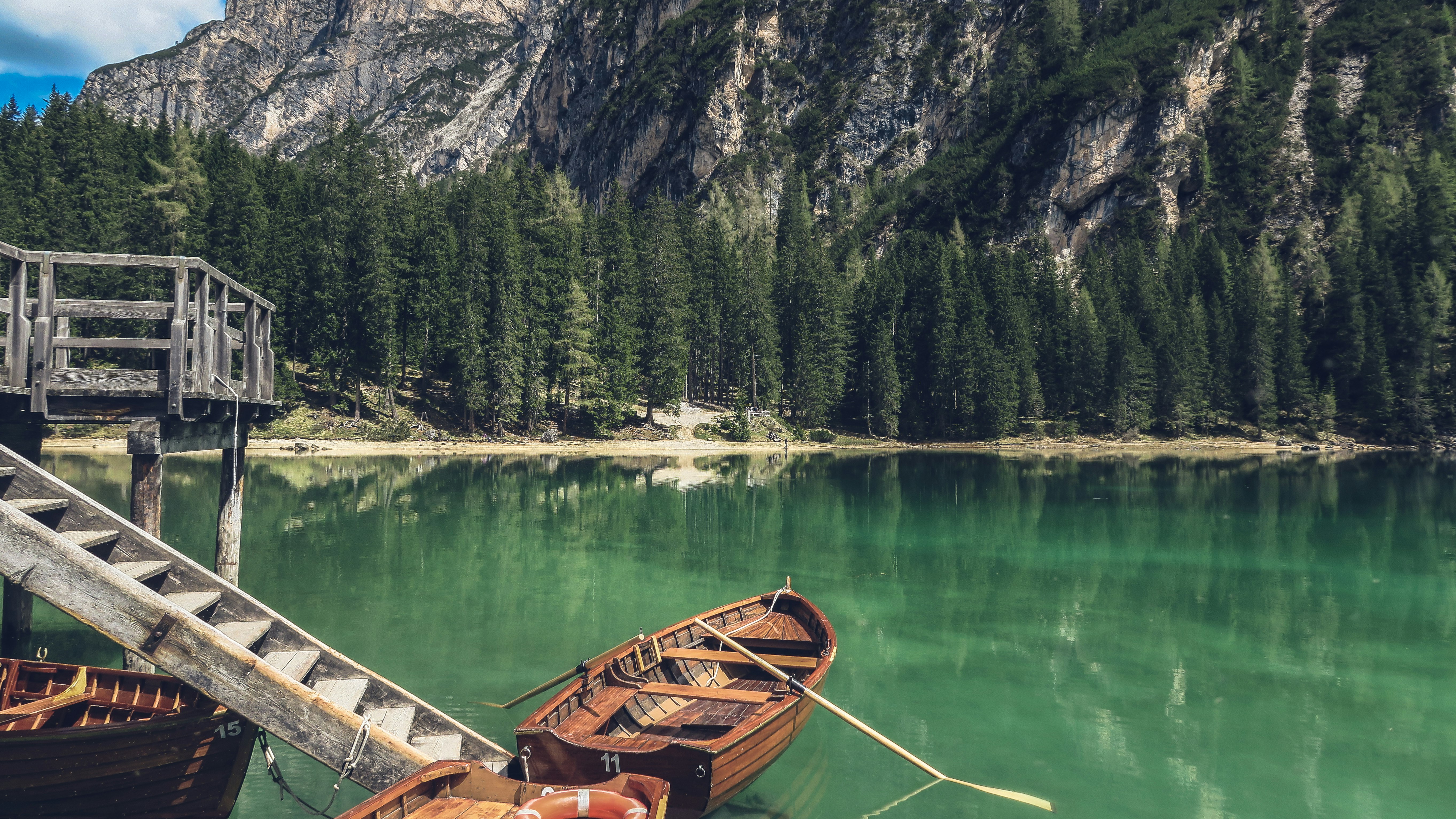 brown canoe docking on gray wooden staircaes