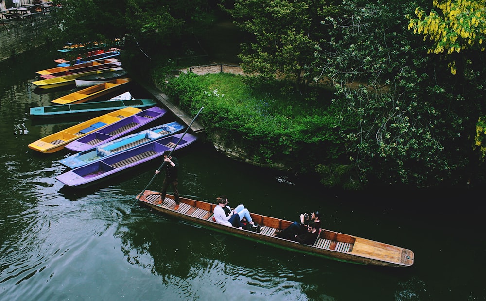 boat on body of water beside green leafed tree