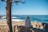 man sitting facing sea