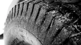 Close-up of a tire inspection showing detailed tread analysis.