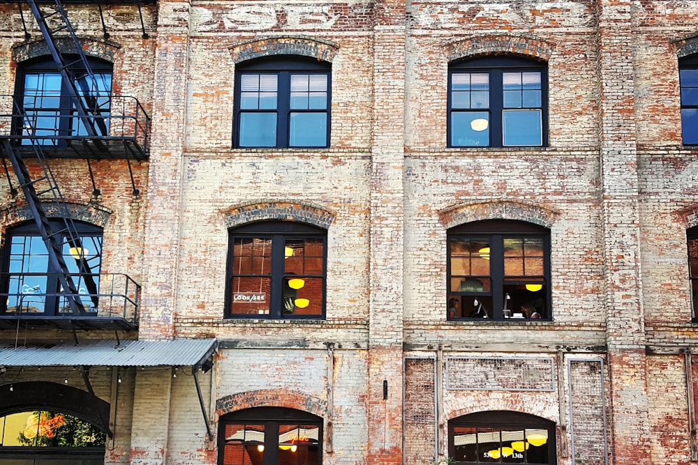 brown concrete building with glass window at daytime