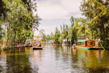 A lively group of friends laughing on a colorful boat tour in a Mexican lagoon