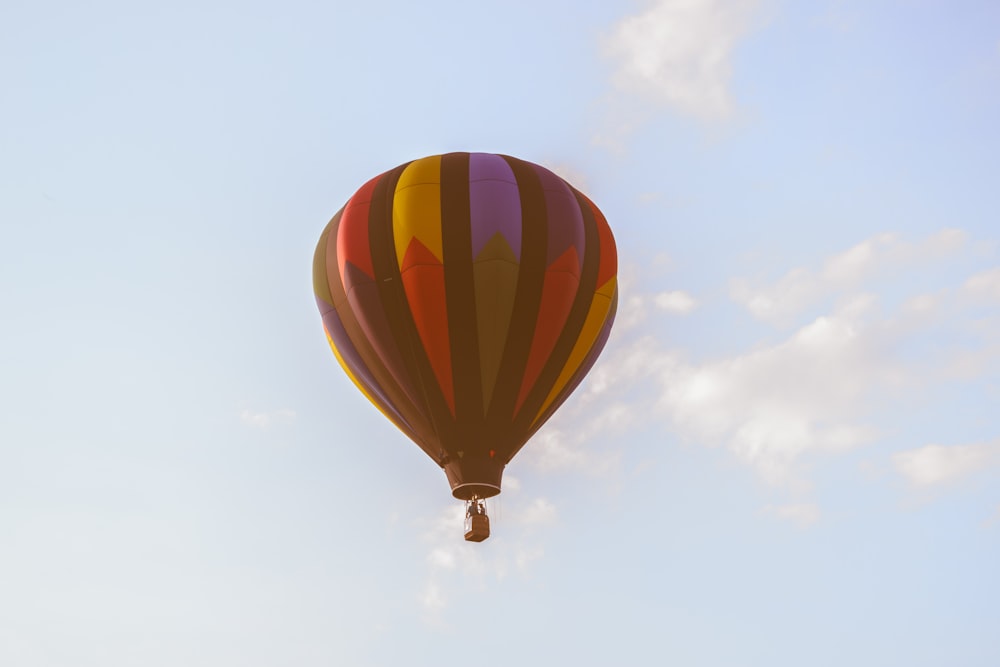 low angle photo of red and black hot air ballon