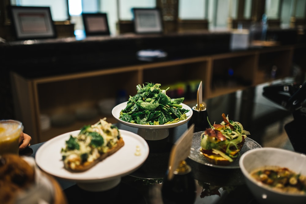 cooked food and salad on white ceramic plates