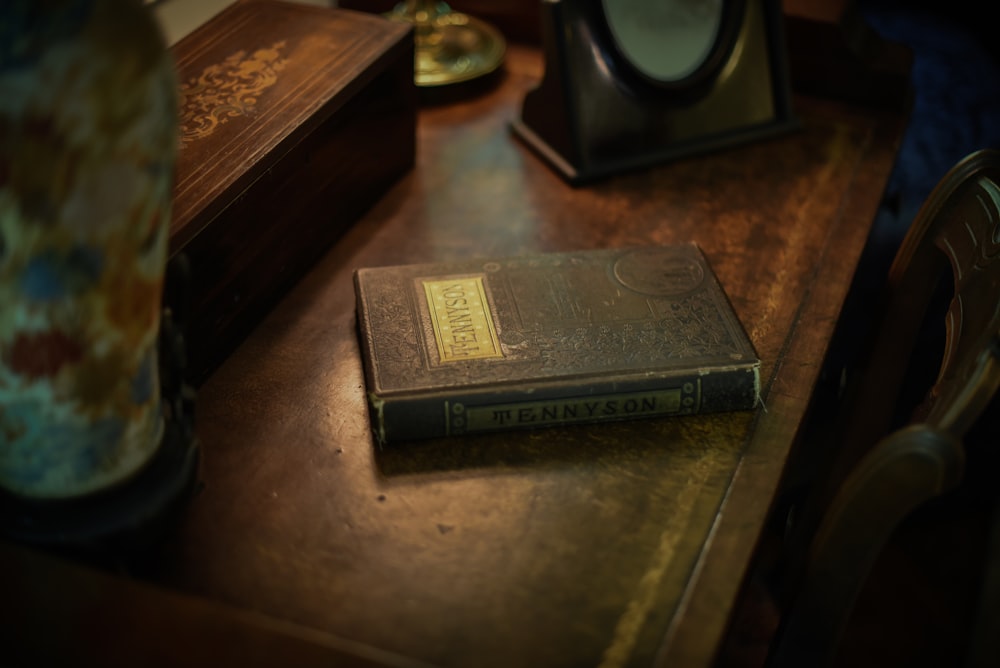 Tennyson covered book on wooden surface near box