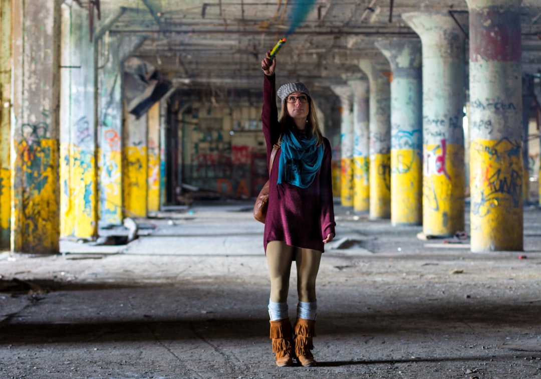 woman standing on gray pavement,