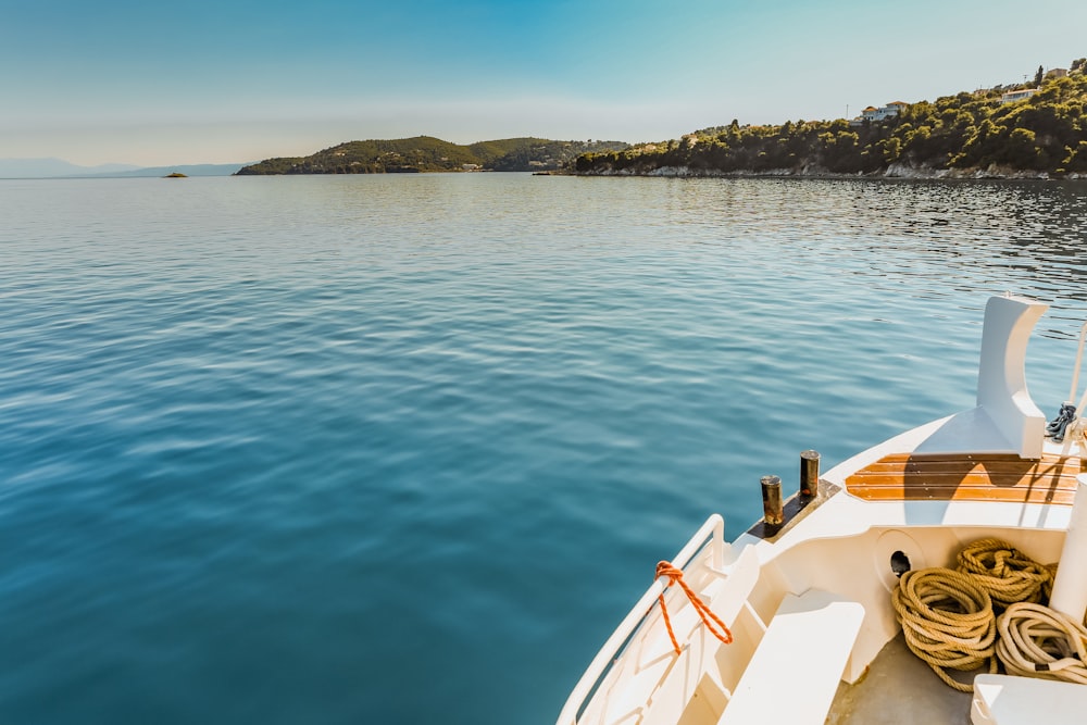 white canoe docked on calm water near island