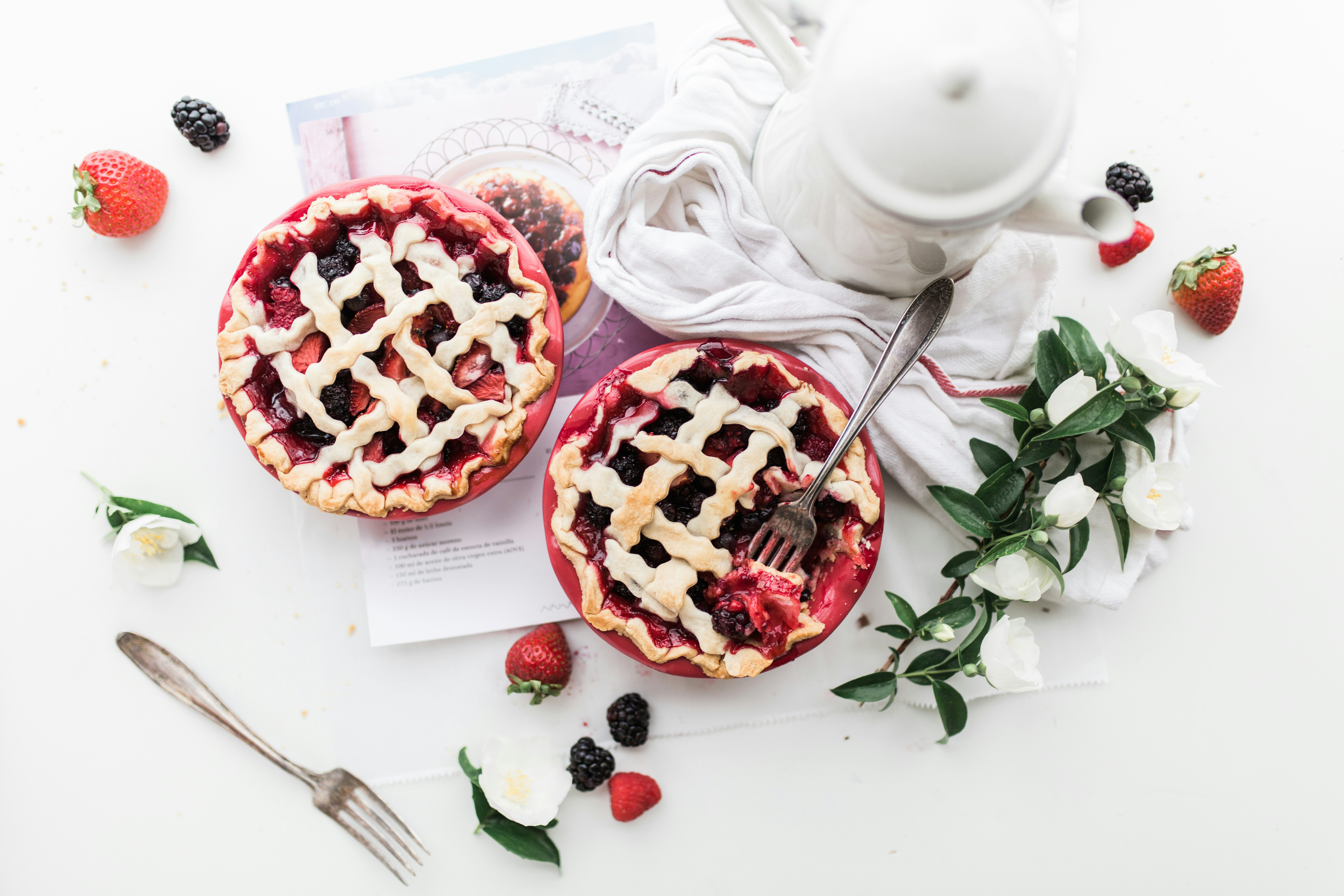 Top view of fruit pies and a coffee pot