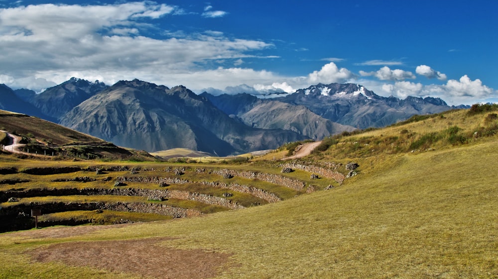 landscape photography of mountain under white clouds and blue sky