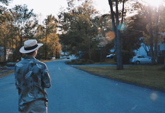 Evening shot of the candidate walking through a leafy neighborhood, engaging in casual conversation with residents.