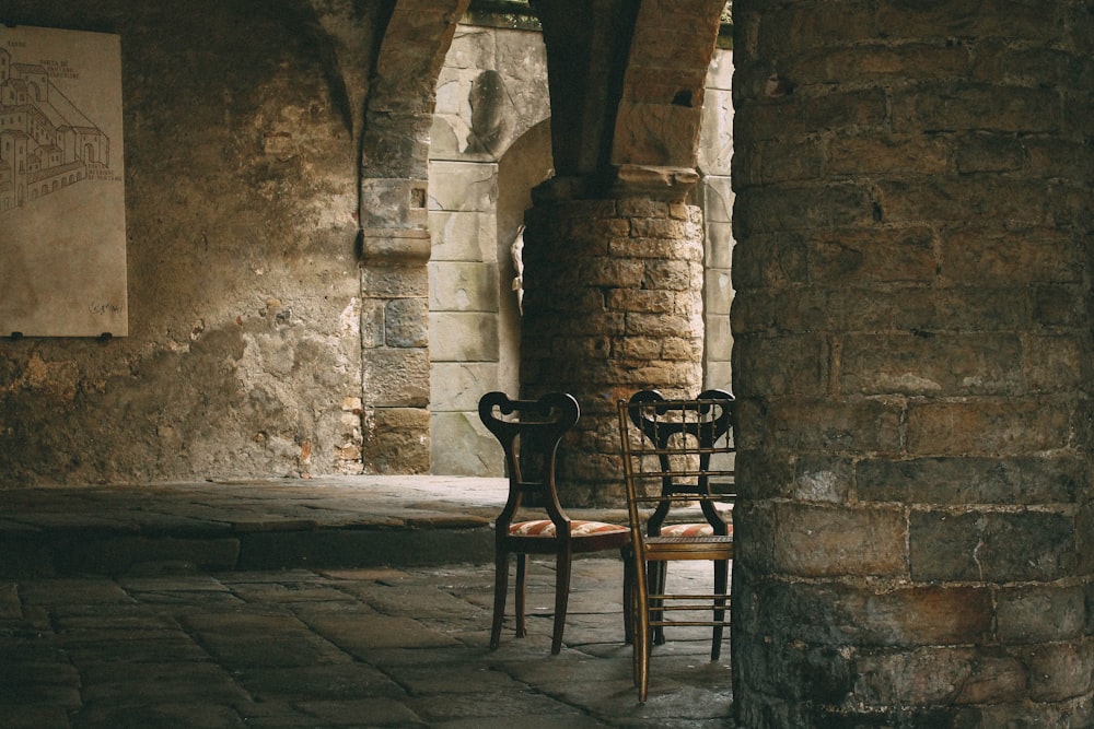 three brown wooden chairs