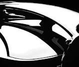 Artistic composition showing a luxury item with reflections on a polished black surface.