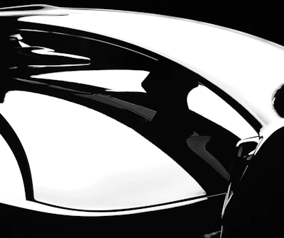 Artistic composition showing a luxury item with reflections on a polished black surface.