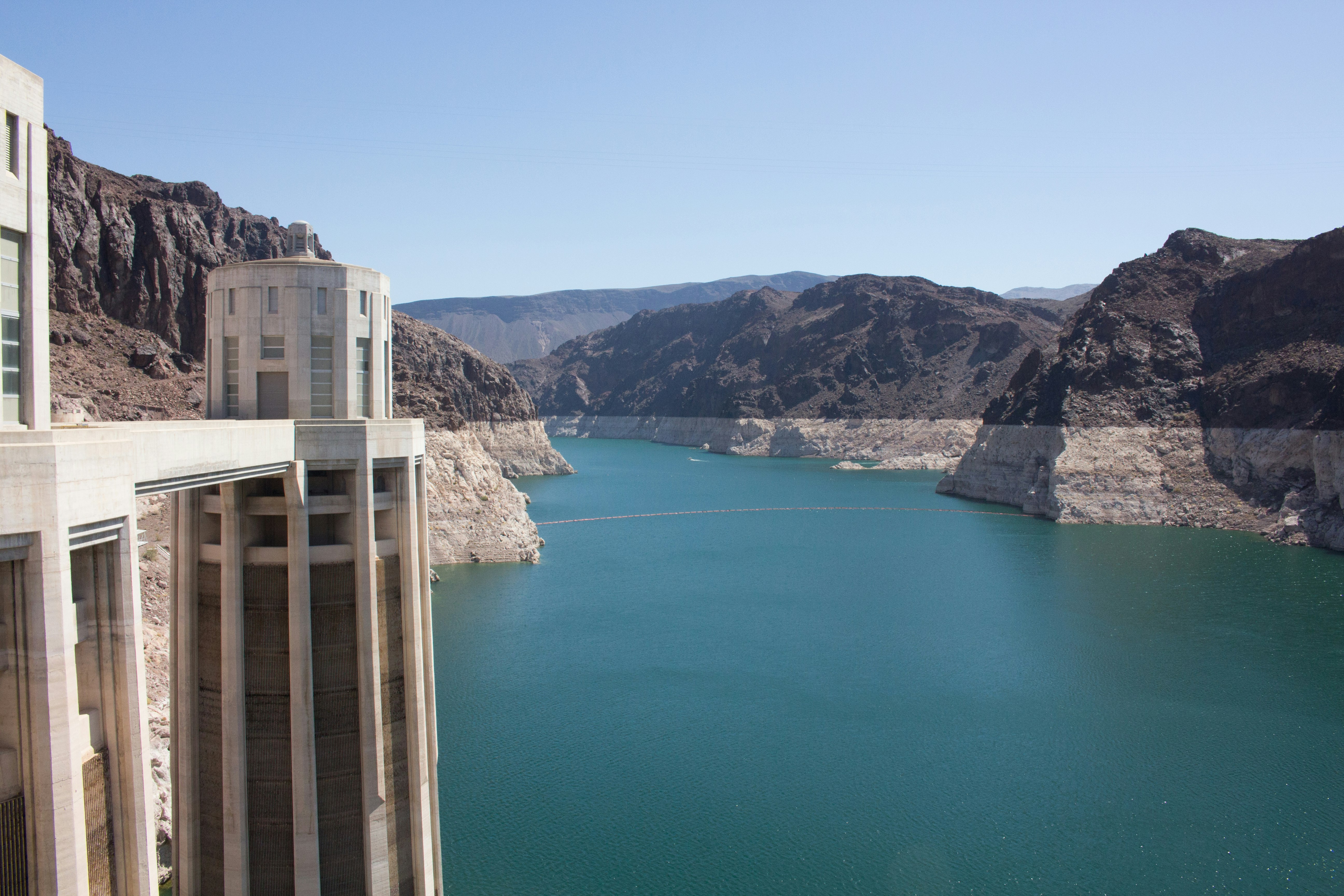 building structure near mountain and body of water