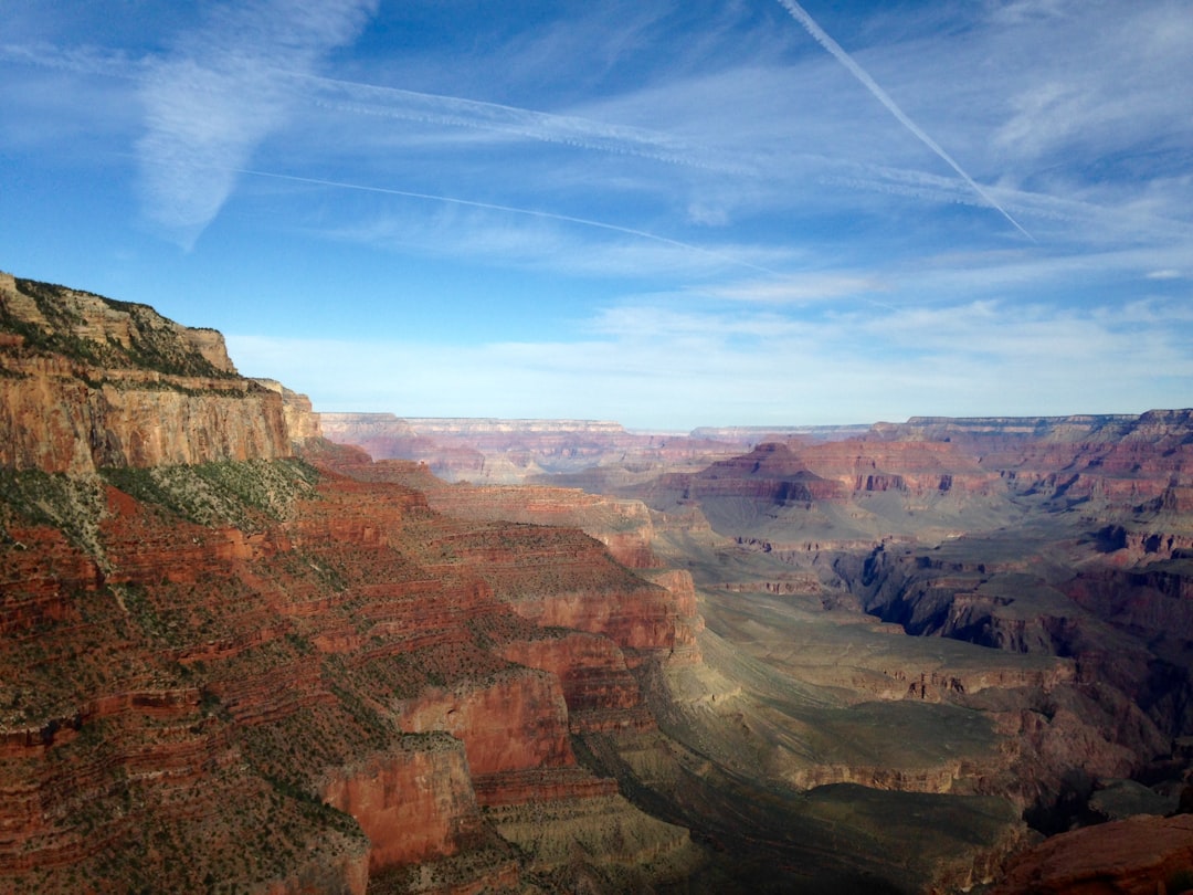 mountains under blue cloudy skies,