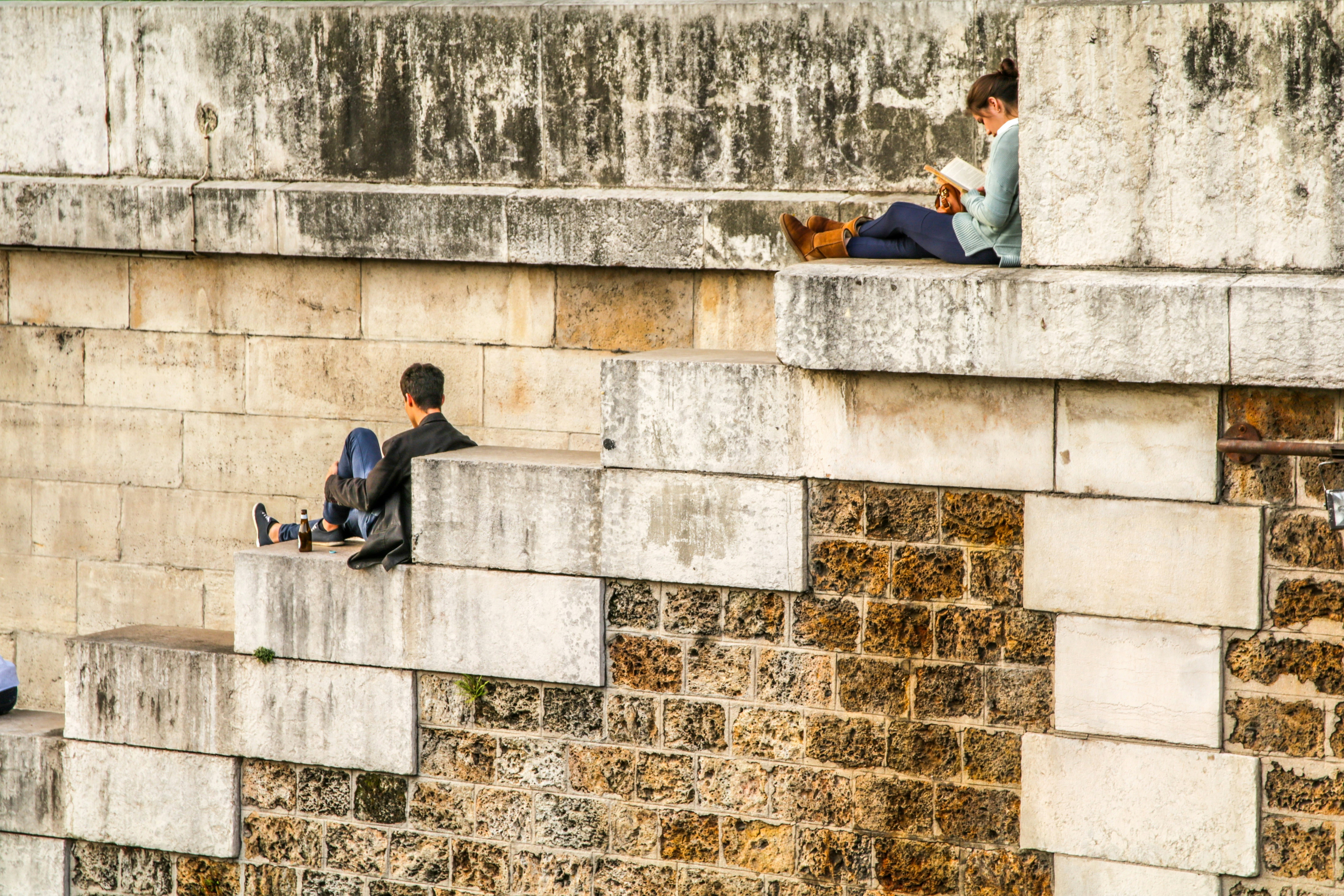 People sitting on large brick stairs