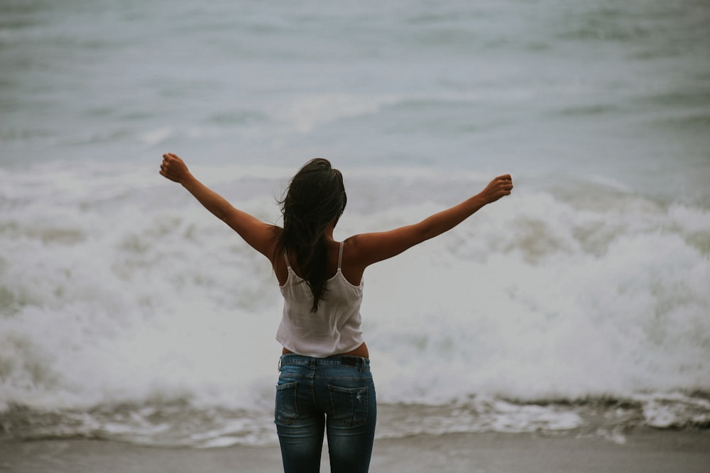 Girl doing arm circle at beach