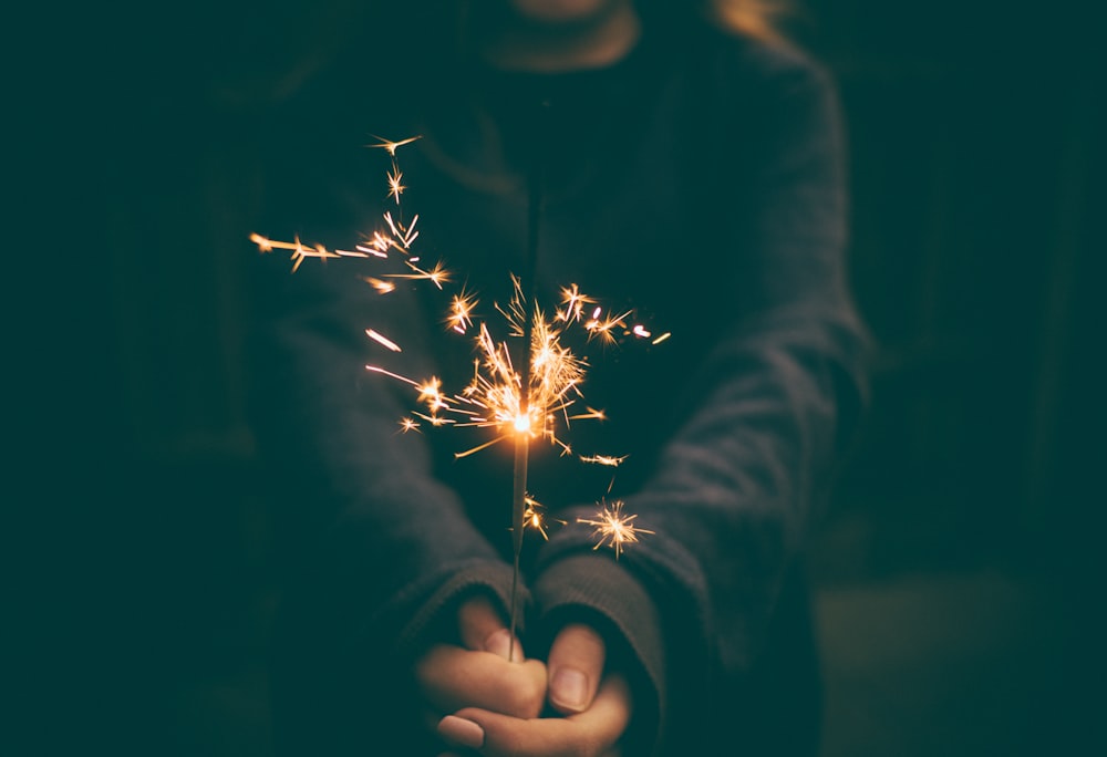 person holding sparkler