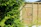 Close-up of a sturdy, beautifully crafted wooden fence surrounded by green landscaping.