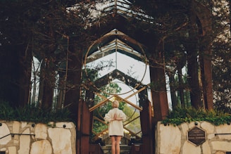 woman standing near green leafed plants