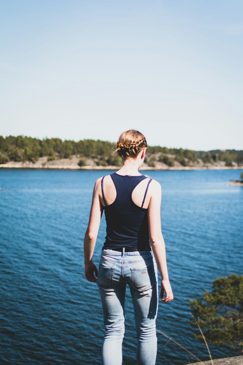 woman fronting body of water