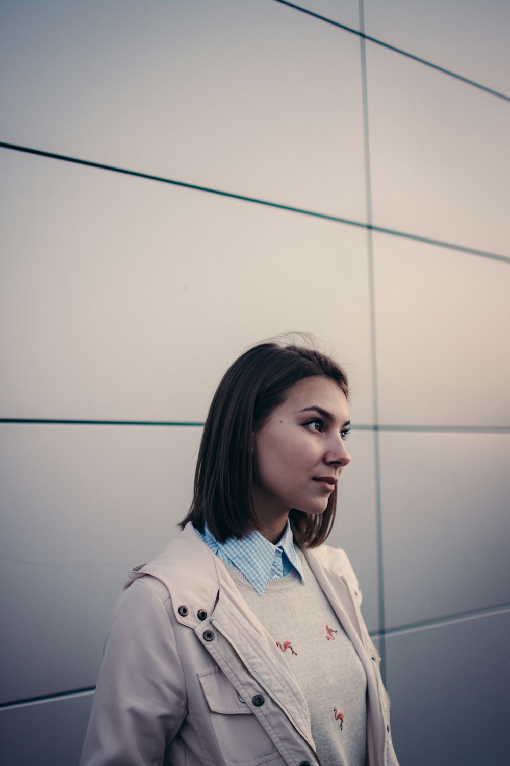 woman in white jacket looking forward