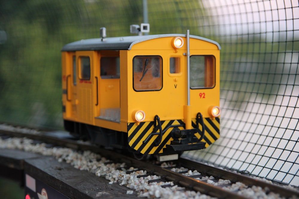 closeup photo of yellow and black train toy