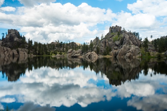 photography of body of water near mountain at daytime in Custer State Park United States